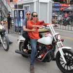 Young couple on their motorcycle at east end of Sturgis Main Street